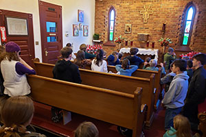 The students gather for prayer in the Adoration Chapel of St. Francis Church